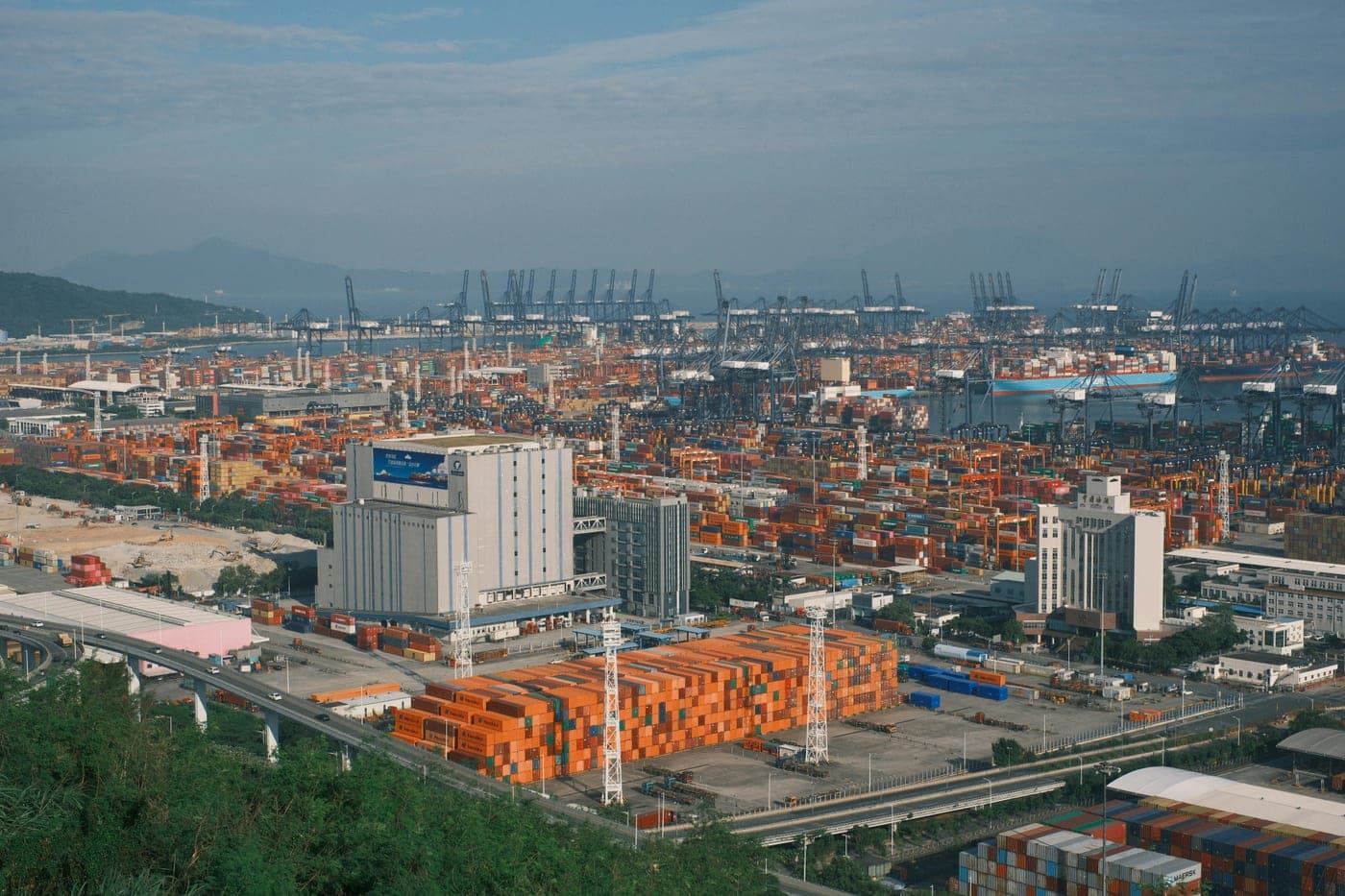 Busy shipping port with cranes and cargo containers